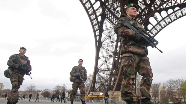 French army soldiers patrol under the Eiffel Tower in Paris on Tuesday January 13.