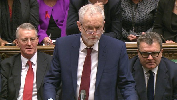 Opposition Labour Party leader, Jeremy Corbyn, centre, makes a speech in the House of Commons in London, flanked by Hilary Benn and Tom Watson