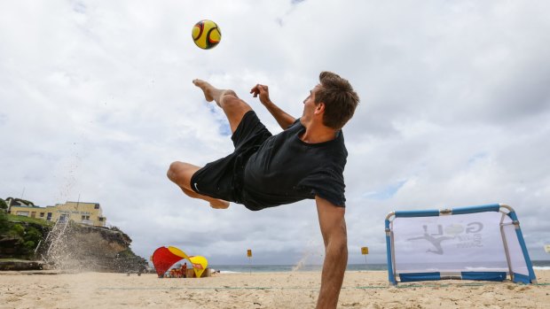 New game: Ex-Socceroo  striker David Zdrilic going through his paces at Tamarama Beach. 