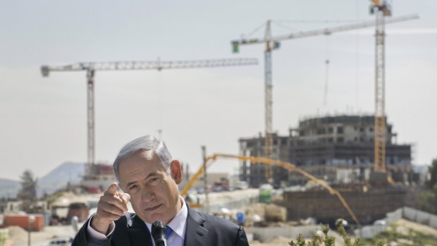 Israeli Prime Minister Benjamin Netanyahu visits a construction site in the east Jerusalem settlement of Har Homa, where he vowed to continue building.