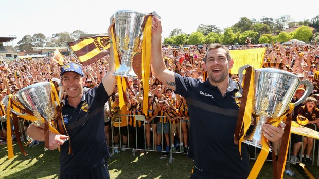 Three-peat: Clarkson and Luke Hodge with the 2013, 2014 and 2015 premiership cups.
