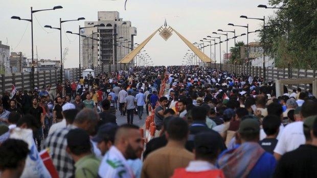 Supporters of Shiite cleric Muqtada al-Sadr cross the Republic Bridge over the Tigris River towards Baghdad's heavily guarded Green Zone on Saturday.