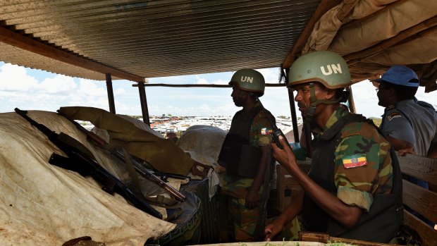 Two UN soldiers from Ethiopia in a guard tower radio their base over a possible security threat near the UN Protection of Civilians site in Juba in April.