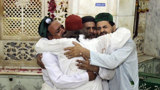 Family members of victims comfort each other after suicide bombers attacked the Data Durbar shrine in Lahore in July 2010.