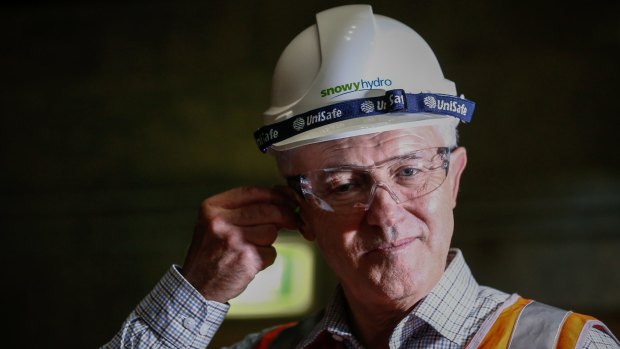 Prime Minister Malcolm Turnbull puts in ear plugs during a visit to the Snowy Hydro plant.