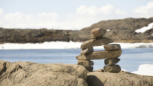 Baffin Island: An inuksuk, a stone landmark or cairn built and used by the Inuit.