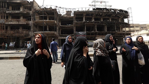 Iraqi women wait for family members missing after the attack.