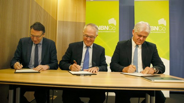 December 2014: then Telstra chief David Thodey (left), Communications Minister Malcolm Turnbull and NBN chief Bill Morrow attend a signing.