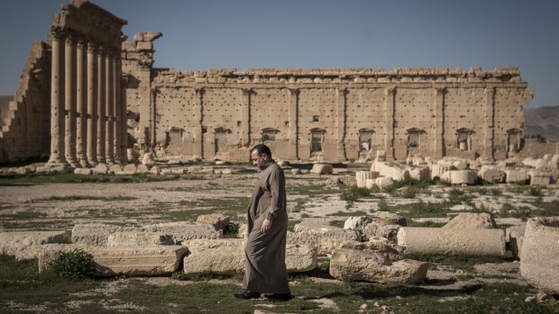 A man walks through the ruins of the Temple of Bel in Palmyra, Syria, in 2014, 