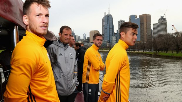 Juventus manager Massimiliano Allegri and players enjoy a boat ride on the Yarra on Tuesday.