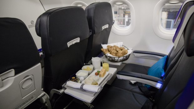 A breakfast meal and a basket of croissants in Joon business class.