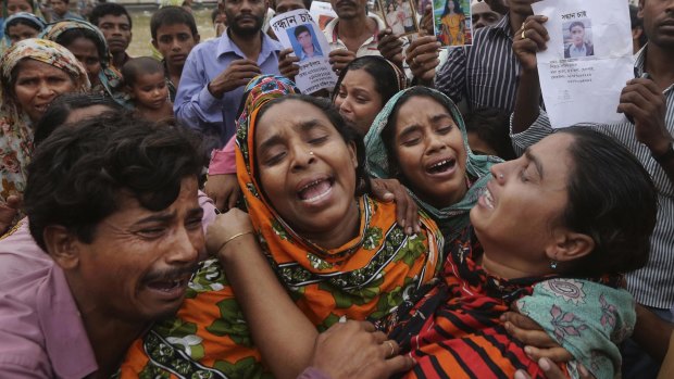 Bangladeshi relatives of garment worker Mohammed Abdullah  arrive to collect his body at a makeshift morgue after the Rana Plaza collapse in April 2013.