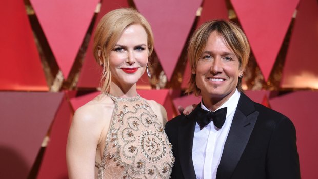 Nicole Kidman, wearing a feature red lip, and Keith Urban arrive at the Oscars on Sunday, Feb. 26, 2017, at the Dolby Theatre in Los Angeles. (Photo by Richard Shotwell/Invision/AP)