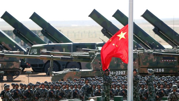 People's Liberation Army troops perform a flag-raising ceremony during the parade.