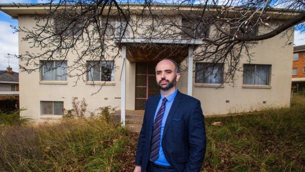 Macedonian ambassador Vele Trpevski  in front of the abandoned Yugoslavian embassy in Red Hill.

