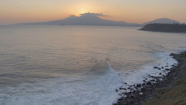 Volcano Mendeleyev is silhouetted against the sunset on Kunashiri Island, one of the Kuril Islands, disputed by Russia and Japan.