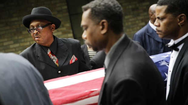 Pallbearers carry the coffin of Walter Scott out from his funeral in Summerville, South Carolina.  