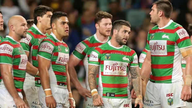 Down and rout: Rabbitohs players look dejected after conceding another try against the Roosters in round 26.