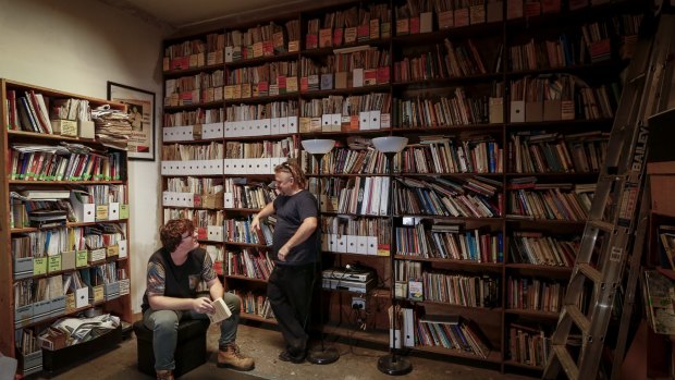 Chris (left) and Fraser Karhunkynsi in the library of the Melbourne Anarchist Club. They claim neighbouring development is causing damage to the building.
