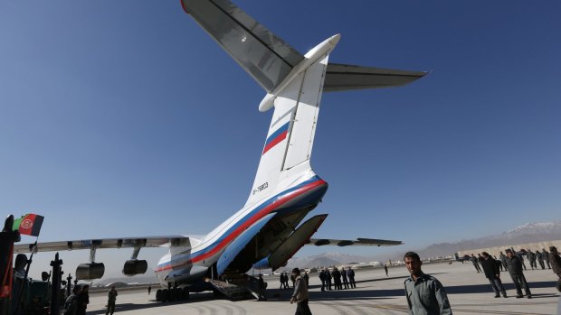 Afghan National security forces gather around a Russian aircraft at International Kabul Airport as the Russian government announced they will hand over 10,000 AK-47s as their military donation to Afghan National Security Forces.