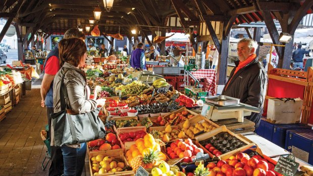 Cruise passengers check out  a market while on a Scenic Tours cruise in France.
