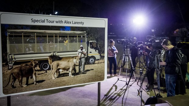 Press gather at the entrance to the lion park, near Johannesburg, after an American woman was killed in an attack. 