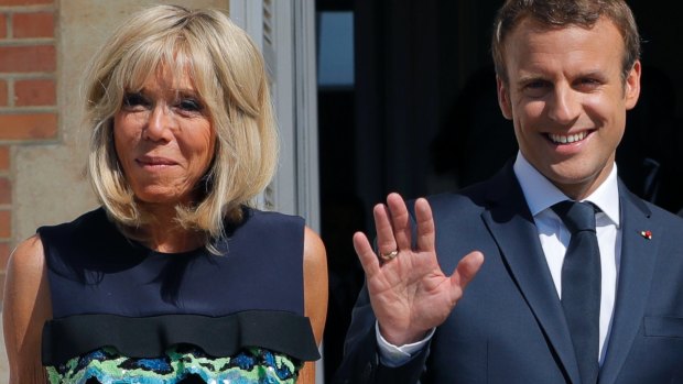 French President Emmanuel Macron, right, and his wife Brigitte who says he needs more time to implement his policies.