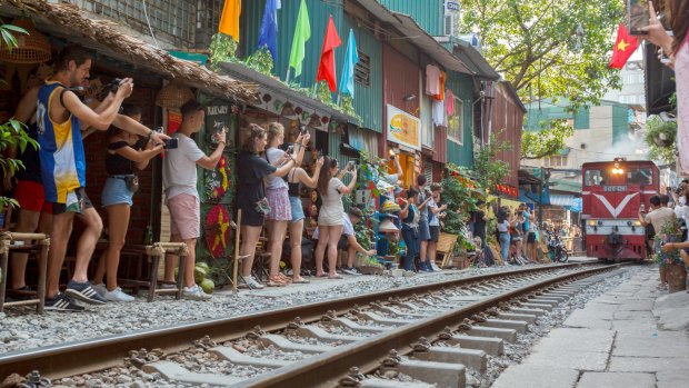 Tourists crowds are causing problems on Hanoi's famous 'Coffee Street' where cafes line the edge of a railway track.