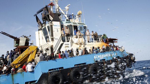 A Libyan Navy boat carries asylum-seekers back to the coastal city of Misrata on Sunday.