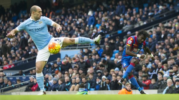 Karate stance: Crystal Palace's Pape N'Diaye Souare crosses a ball past Manchester City's Pablo Zabaleta.
