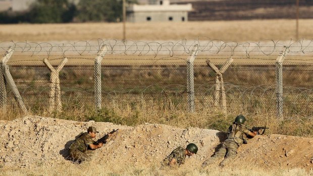 Turkish soldiers in position near the Syrian border in the Turkish border town of Akcakale on Monday.