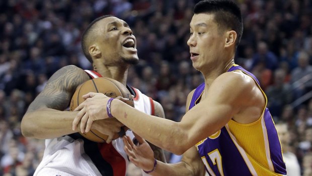 Struggle for possession: Portland Trail Blazers guard Damian Lillard fights for the ball with Los Angeles Lakers rival Jeremy Lin last season.