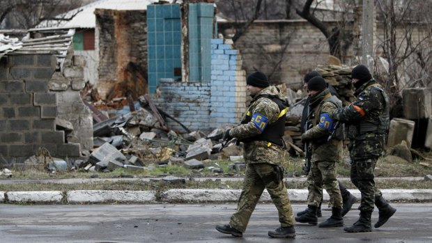 Ukrainian soldiers patrol the village of Debaltseve in the war-torn Donetsk region.