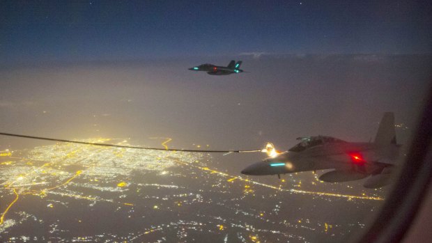 Two RAAF F/A-18F Super Hornet aircraft conduct air to air refuelling over the skies of Iraq. Dan Tehan said the Hornet fighter jets should be launching air strikes in Syria as well as Iraq.