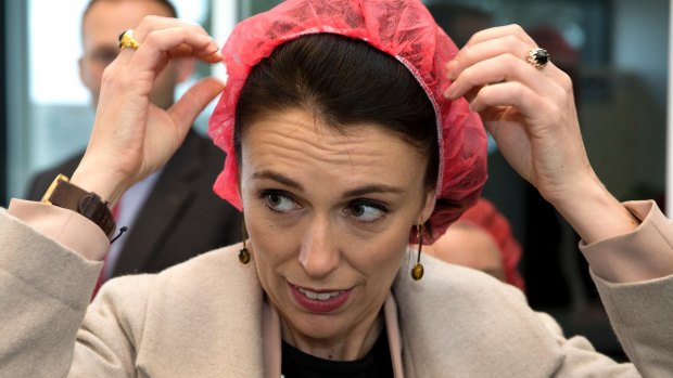 NZ Labour Party leader Jacinda Ardern puts on a hair net at a mushroom factory while campaigning in Christchurch on Thursday.
