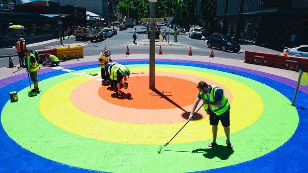 Adam Hale painting the green