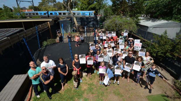 Murumbeena residents in the backyard of one of the homes adjacent to where the elevated "skyrail" will soon be built. 