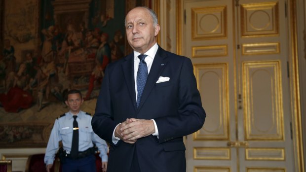 Not amused: French Foreign Affairs Minister Laurent Fabius briefs the media.