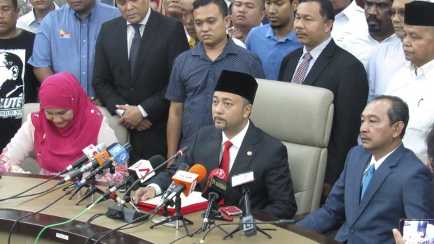 Mukhriz Mahathir, centre, the son of former Malaysian prime minister Mahathir Mohamad, at  a press conference in Kedah, Malaysia, on Wednesday. Mr Mukhriz claims he was ousted from his chief ministership of Kedah state because he criticised Najib Razak.