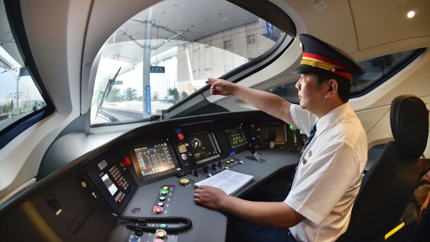 A train driver prepares to operate the Fuxing bullet train.