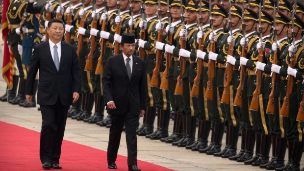 China's President Xi Jinping, left, and Brunei's Sultan Hassanal Bolkiah review an honour guard in Beijing last month.