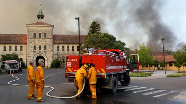 Firefighters tackle a bushfire in Winmalee near St Columba's School in October 2013.