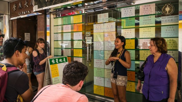 As other tourists flock to wealthy shopping districts, some learn from guides like Lau about Hong Kong's underpaid domestic workers and volatile politics. 