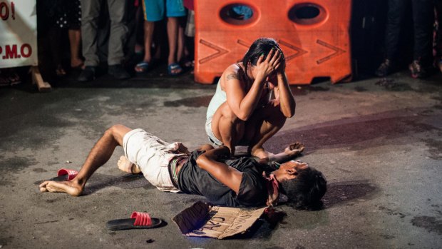 Jennilyn Olayres weeps over the body of her husband Michael Siaron after armed assailants in a motorcycle shot him in a main thoroughfare in Manila in July.