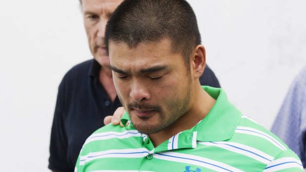 Andrew Chan's brother, Michael, holds back tears.
