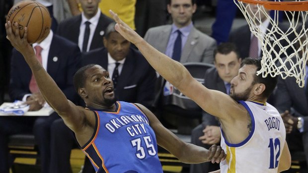 Stars on the move: Oklahoma City Thunder forward Kevin Durant tries to shoot against Golden State Warriors centre Andrew Bogut during Game 5 of the Western Conference finals in Oakland.