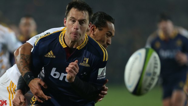 Contact: Ben Smith just gets his pass away for the Highlanders before Chiefs opponent Hosea Gear wraps him up.