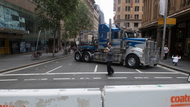 Semi-trailers and concrete bollards were used to block streets in Sydney during the Boxing Day sales.