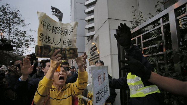 A protester shouts slogans outside the China Liaison Office in Hong Kong during a protest last month. 