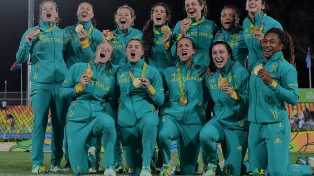 The Australian women's rugby sevens team celebrates their gold medal.